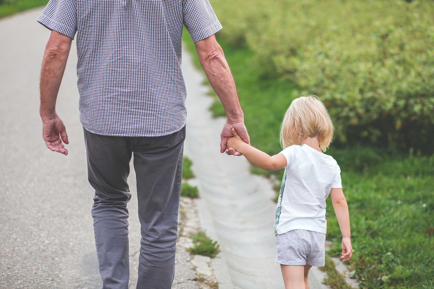 Father Walking Hand-in-Hand With Child